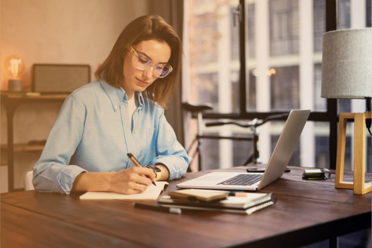 woman with a laptop and paperwork