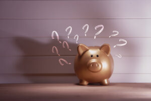 piggy bank with lots of question mark symbol . Concept Are structured settlements a good idea