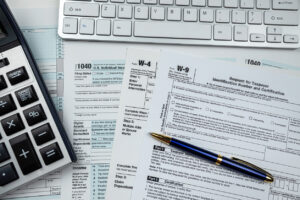 us tax form with calculator and keyboard on office desk. Financial accounting concept