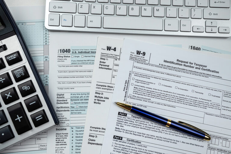 us tax form with calculator and keyboard on office desk. Financial accounting concept